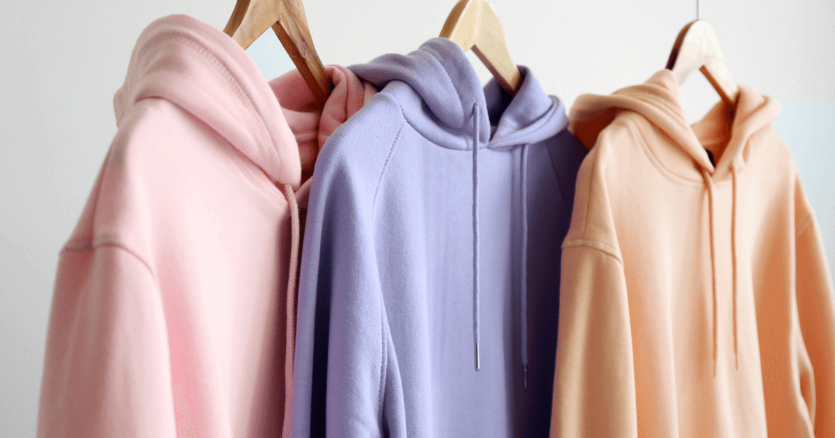 Three pastel-colored hoodies hanging neatly, displayed next to the introduction of Old Navy's return policy page.